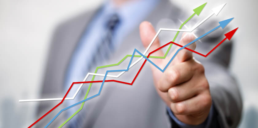 Businessman pointing to growth in a line graph showing business success